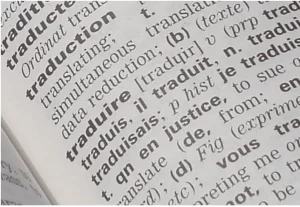 An open book showing the word 'traduction,' representing professional English to French translation services tailored for businesses and individuals."